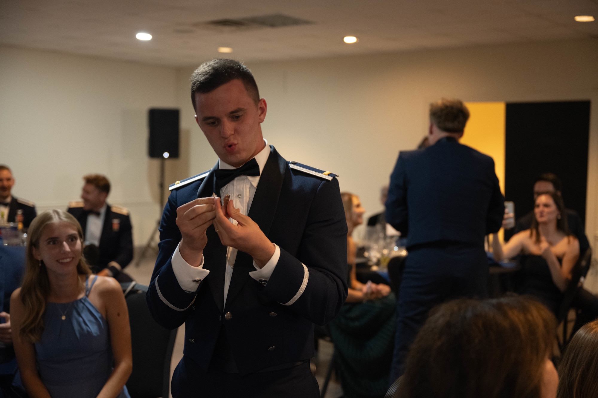 U.S. Air Force 2nd Lt. John Thomson, 47th Student Squadron pilot breaks their silver wings at Laughlin Air Force Base, Texas, Aug. 7, 2025.  The breaking of silver wings is a tradition dating back to the U.S. Army Air Corps where a pilot's first wings are not to be worn but broken and given to a loved one. (U.S. Air Force photo by Airman 1st Class Darryl Keith.)