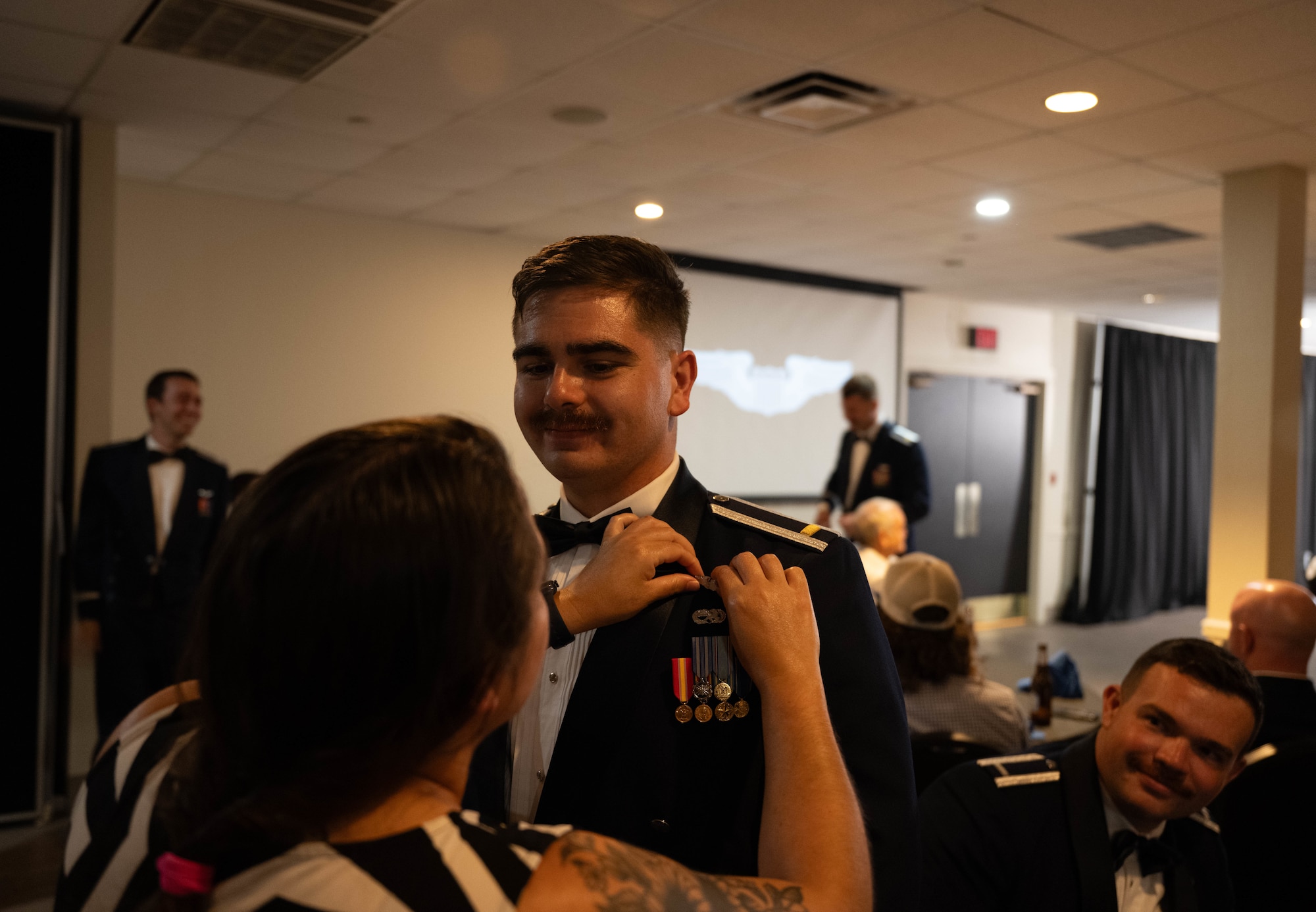 A loved one pins silver wings on U.S. Air Force 2nd Lt. Michael Russell, 47th Student Squadron pilot, at Laughlin Air Force Base, Texas, Aug. 7, 2025.  Graduating pilots were awarded silver wings symbolizing their successful completion of Undergraduate Pilot Training.  (U.S. Air Force photo by Airman 1st Class Darryl Keith.)