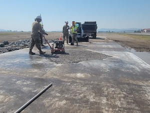 People fix a concrete pad