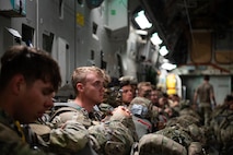 U.S. Soldiers sit on a C-17 Globemaster III aircraft.