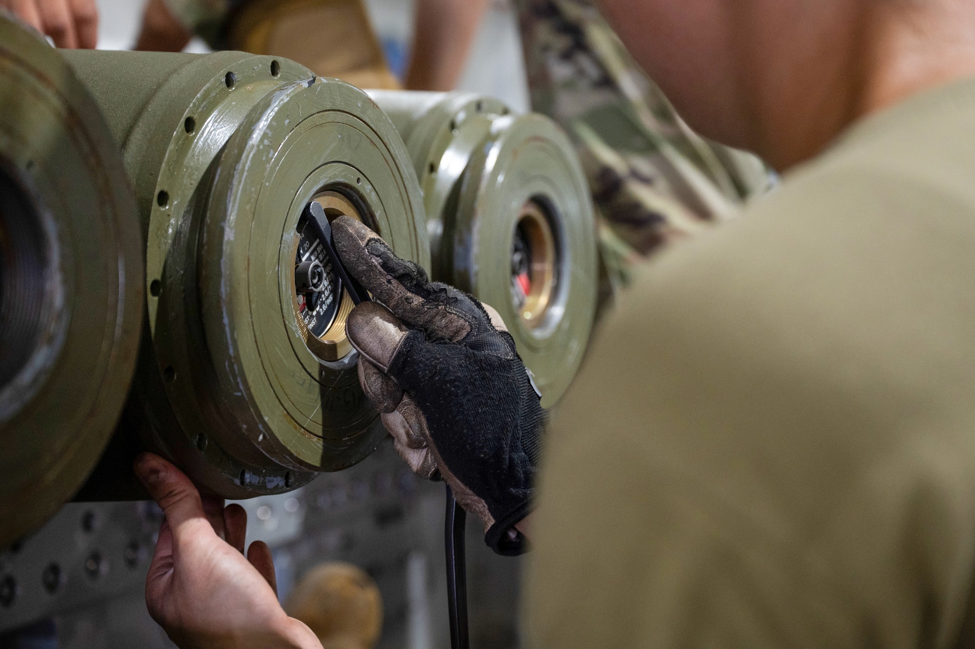 An Airmen assigned to the 5th Munitions Squadron (5MUNS) tightens the fuses on the back of a MK-82 conical munition at Minot Air Force Base, North Dakota, August, 4, 2025. 5MUNS will compete in the Air Force Combat Operations Competition designed to test adaptability and technical sharpness.