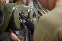 An Airmen assigned to the 5th Munitions Squadron (5MUNS) tightens the fuses on the back of a MK-82 conical munition at Minot Air Force Base, North Dakota, August, 4, 2025. 5MUNS will compete in the Air Force Combat Operations Competition designed to test adaptability and technical sharpness.