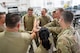 U.S. Air Force Airmen from the 5th Munitions (5MUNS) huddle after completing a training event at Minot Air Force Base, North Dakota, August 4, 2025. 5MUNS is training in preparation for the Air Force Combat Operations Competition, where they will compete against other munitions squadrons in munition building exercises.