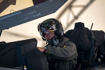 Pilot sitting in plane.