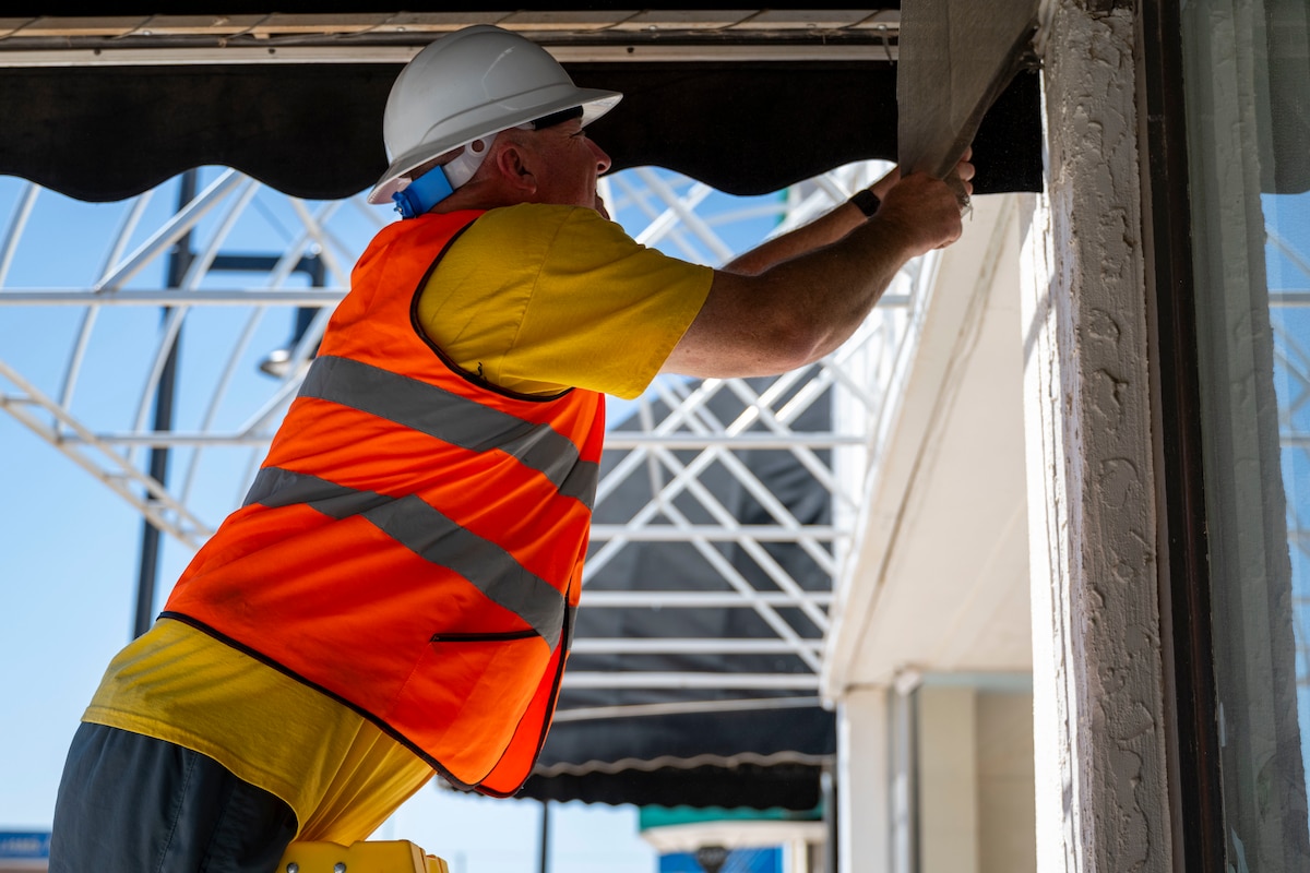 U.S. Air Force Master Sgt. Derrick Glover, 54th Operation Support Squadron radar and weather systems section chief, removes a part of an awning at Alamogordo, New Mexico, July 25, 2025.