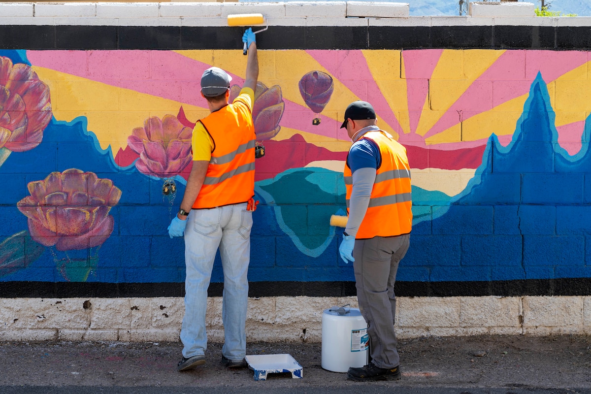 U.S. Air Force Senior Airman Albert Mitz, 54th Operation Support Squadron radar and weather systems supervisor, left, and U.S. Air Force Airman Jose Suacedo, 54th OSS RAWS technician, apply a protective coating over a mural at Alamogordo, New Mexico, July 25, 2025.