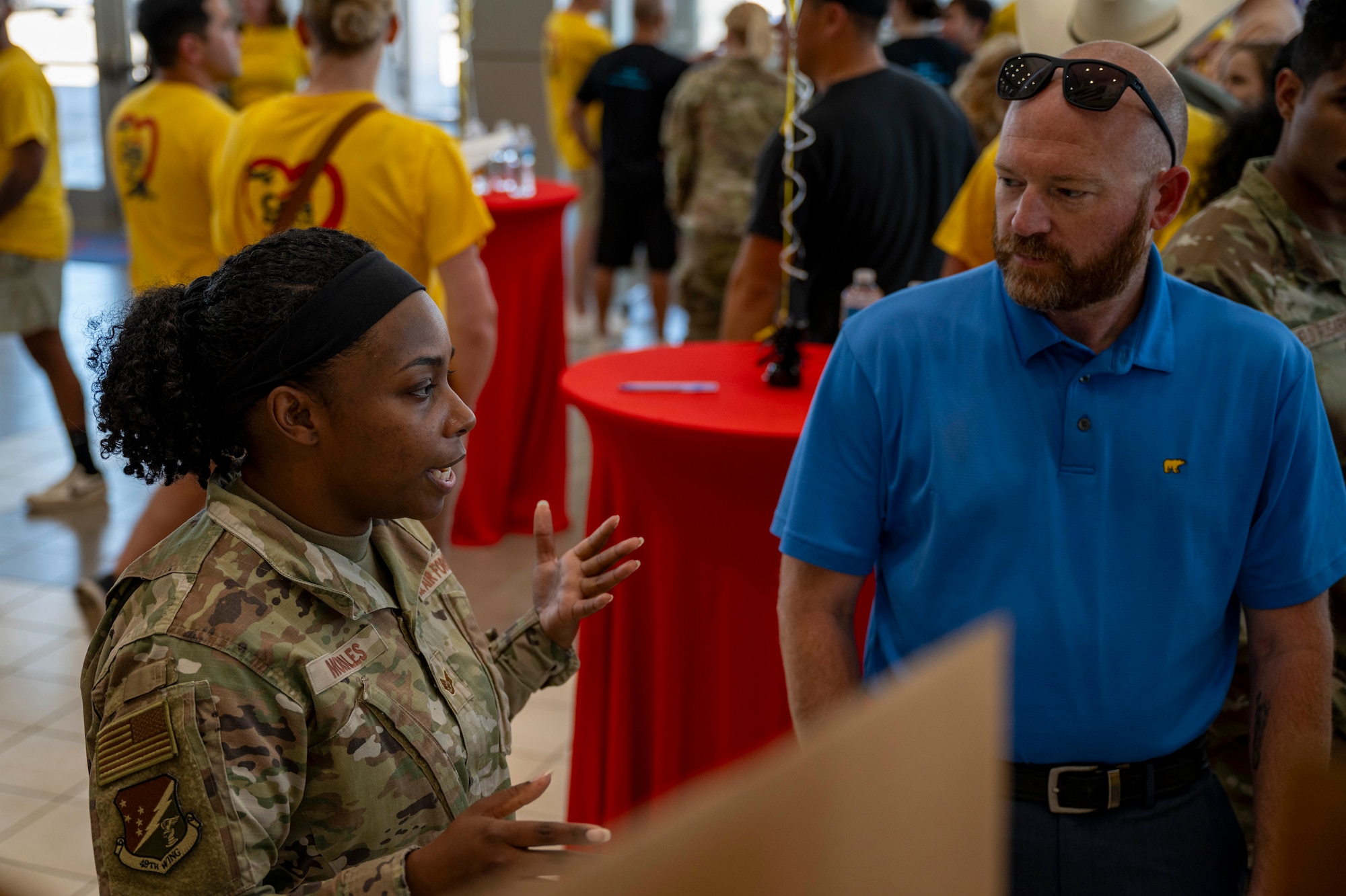 U.S. Air Force Staff Sgt. Kiara Morales, 49th Wing Chapel NET analyst supervisor, left, speaks to Danny Houze, Home Depot store manager, about her team’s Big Give project during the closing ceremony at Alamogordo, New Mexico, Aug. 5, 2025.