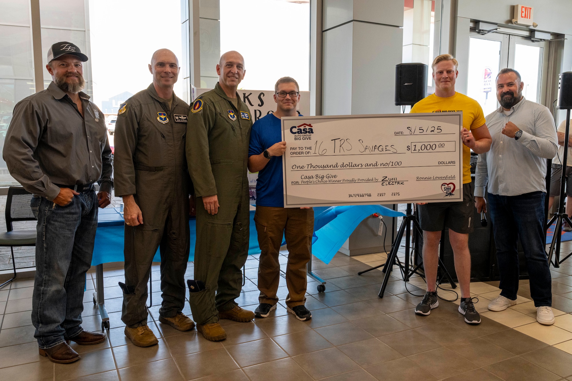 Members from the 16th Training Squadron accept a check for winning the People’s Choice category during the closing ceremony of the 2025 Casa Big Give at Alamogordo, New Mexico, Aug. 5, 2025.