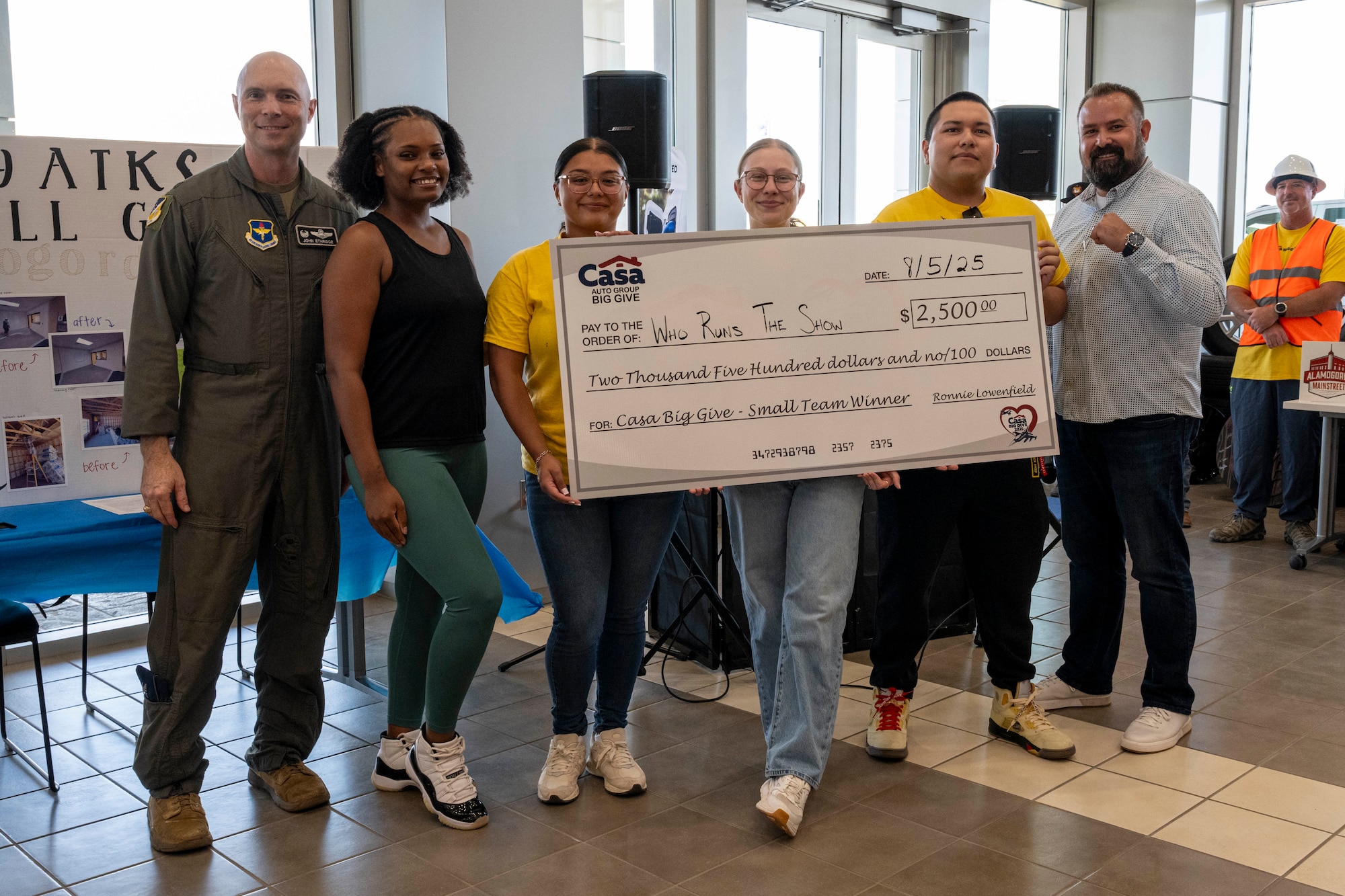 Members from the 49th Maintenance Operations flight accept a check for the Small Team category during the closing ceremony of the 2025 Casa Big Give at Alamogordo, New Mexico, Aug. 5, 2025.