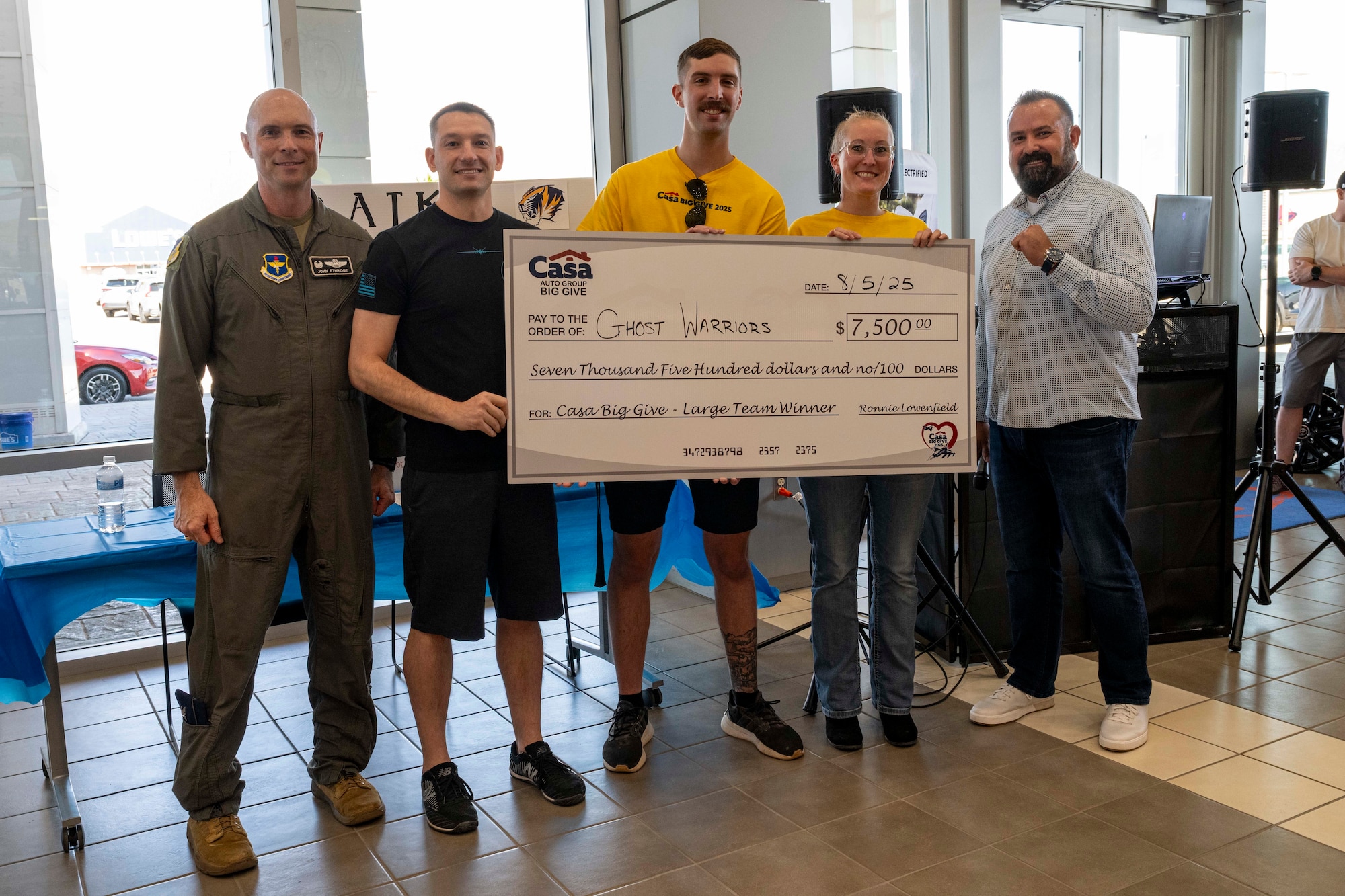 Members from the 29th Attack Squadron accept a check for the Large Team category during the closing ceremony of the 2025 Casa Big Give at Alamogordo, New Mexico, Aug. 5, 2025.