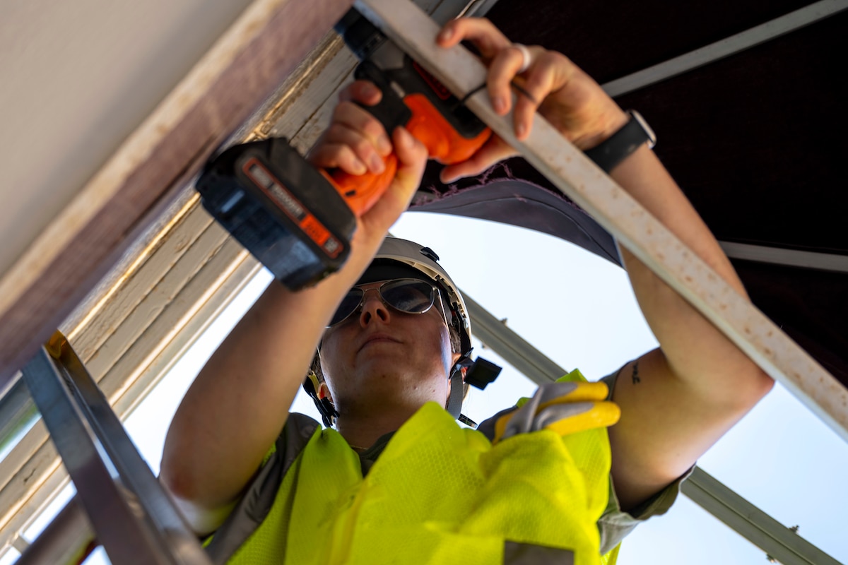 U.S. Air Force Staff Sgt. Bailey Biles, 54th Operation Support Squadron radar and weather systems supervisor, tears down an awning at Alamogordo, New Mexico, July 25, 2025.