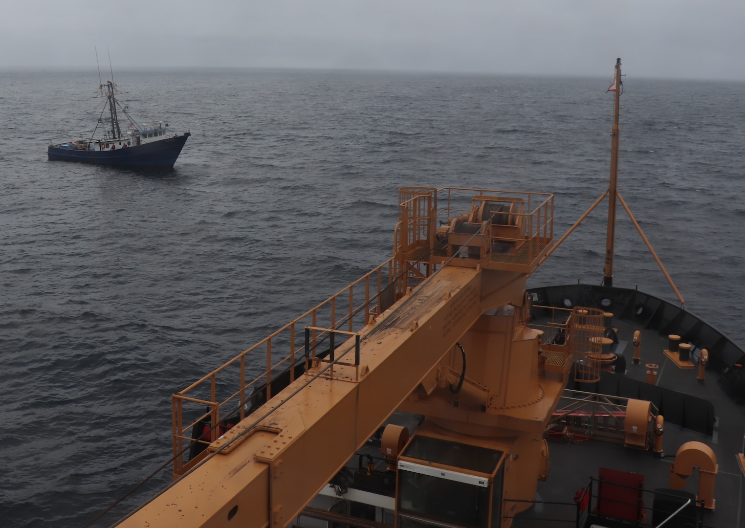 The buoy deck of the Coast Guard Cutter Alder is seen as it arrives on scene next to the fishing vessel Defiant.