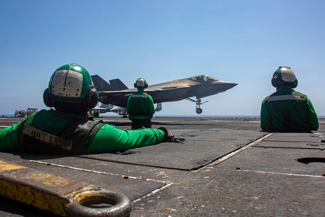 Sailors observe an F-35C Lightning II, attached to Marine Fighter Attack Squadron 314, make an arrested landing on the flight deck of the Nimitz-class aircraft carrier USS Abraham Lincoln (CVN 72).