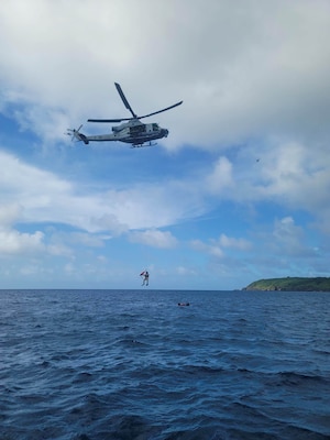 Service members doing simulated ocean rescue.