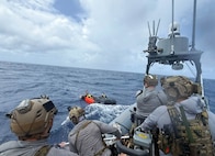 Service members doing simulated ocean rescue