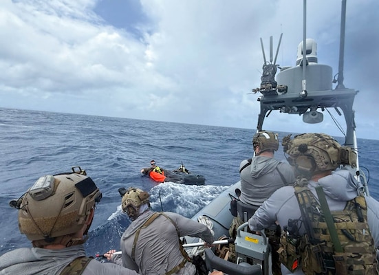 Service members doing simulated ocean rescue