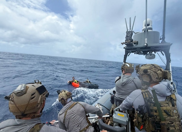 Service members doing simulated ocean rescue