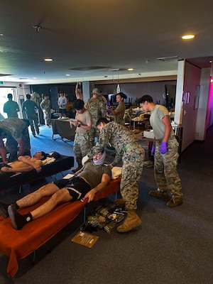 Service members treating simulated patients.