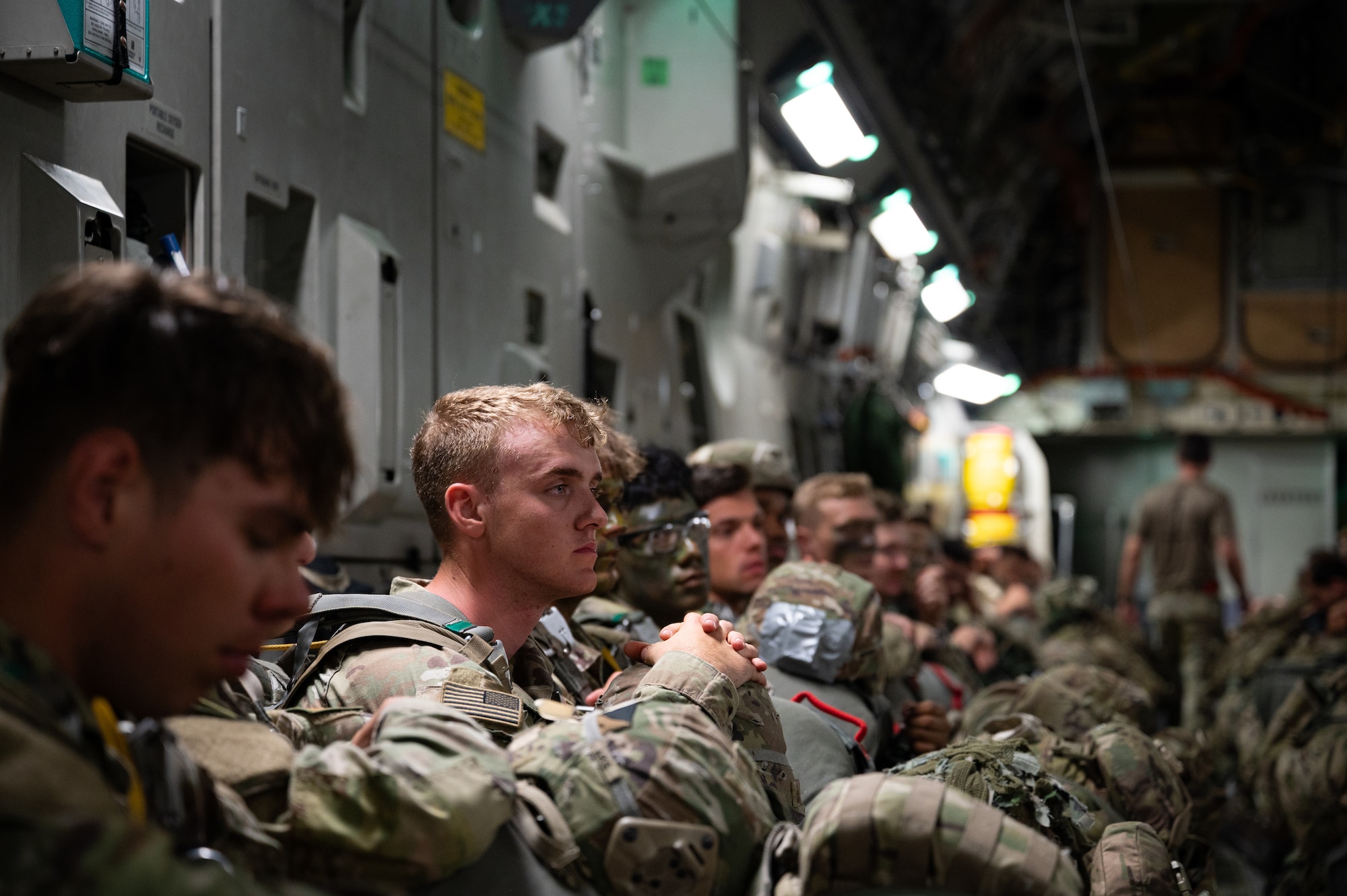 U.S. Soldiers sit on a C-17 Globemaster III aircraft.
