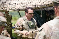 U.S. Army Lt. Col. David Caudle, commander of 1st Battalion, 109th Infantry Regiment, 2nd Infantry Brigade Combat Team, 28th Infantry Division, briefs observers during a demonstration at Fort Indiantown Gap, Pennsylvania, July 28, 2025. The Soldiers and representatives from Carnegie Mellon University’s Software Engineering Institute demonstrated Project Shrike, an AI-enabled system for rapid target recognition and fire adjustment, by integrating drones and artillery during live-fire training. (U.S. Army National Guard photo by Maj. Travis Mueller)