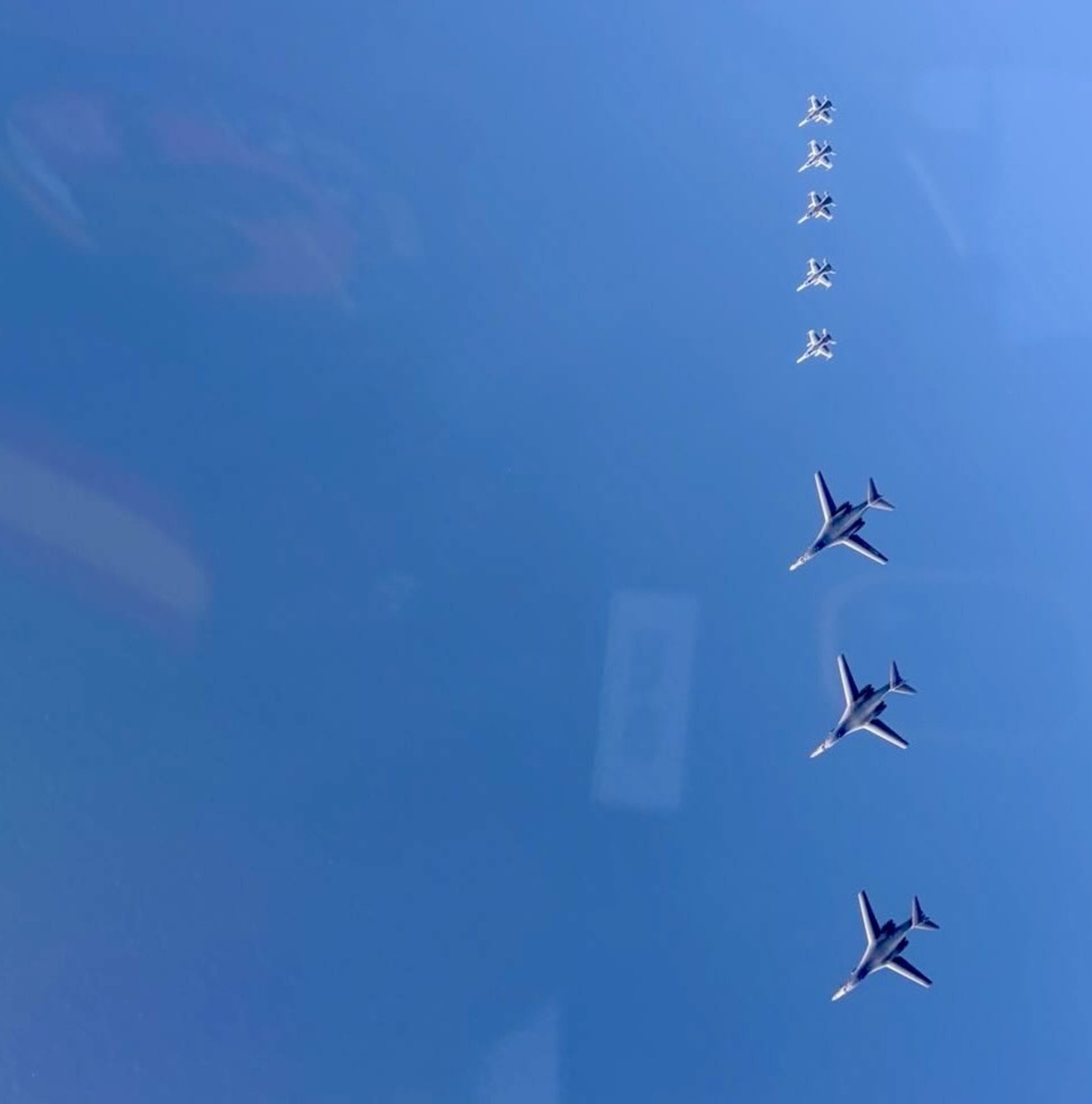 a group of jets in formation in the sky