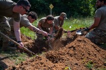 U.S. Air Force Airmen assigned to the 22nd Air Task Force, prepare a burial as part of a training during Exercise Northern Strike 25-2 at Battle Creek Air National Guard Base, Michigan, Aug. 8, 2025.