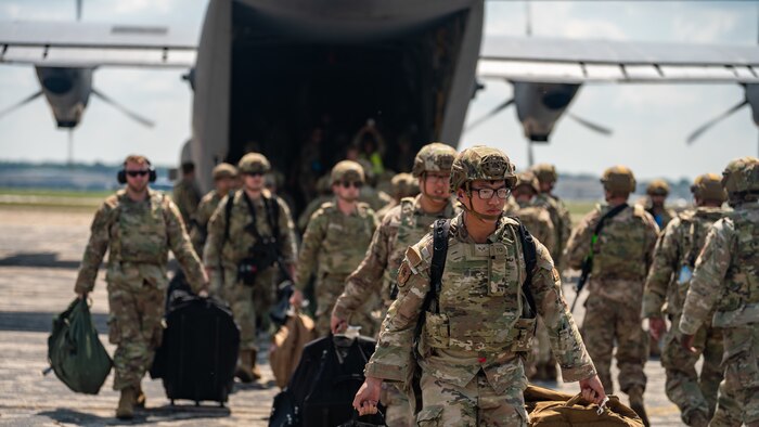 U.S. Airmen from various installations assigned to the 22nd Air Task Force disembark a C-130J Super Hercules assigned to the 815th Airlift Squadron, on the flight line during Exercise Northern Strike 25-2 (NS 25-2) at Battle Creek Air National Guard Base, Michigan, Aug. 8, 2025.