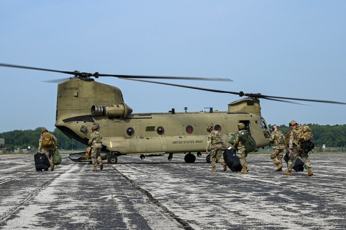 U.S. Airmen from various installations assigned to the 22nd Air Task Force approach a CH-47 Chinook assigned to Bravo Company, 3-238th General Support Aviation Battalion at Selfridge Air National Guard Base, during Exercise Northern Strike 25-2 at Battle Creek Air National Guard Base, Michigan, Aug. 4, 2025.