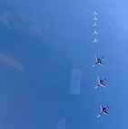 a group of jets in formation in the sky