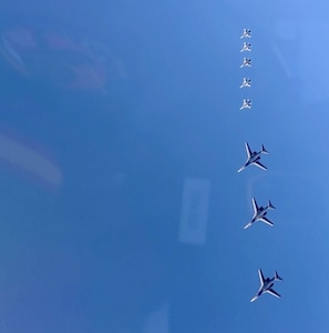 a group of jets in formation in the sky