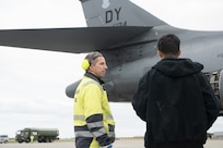 2 men standing by a jet