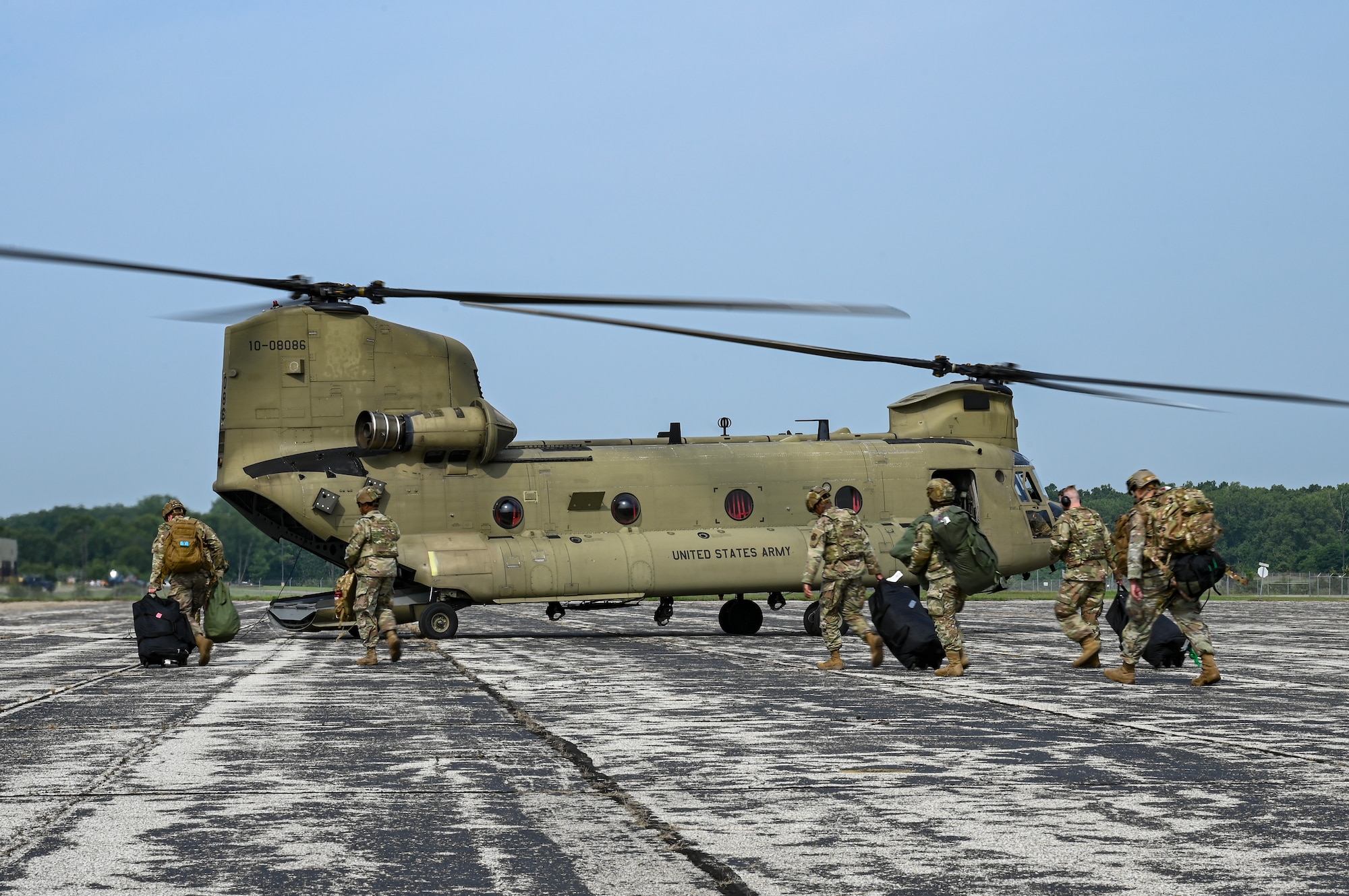 U.S. Airmen from various installations assigned to the 22nd Air Task Force approach a CH-47 Chinook assigned to Bravo Company, 3-238th General Support Aviation Battalion at Selfridge Air National Guard Base, during Exercise Northern Strike 25-2 at Battle Creek Air National Guard Base, Michigan, Aug. 4, 2025.