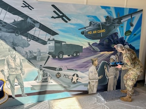 cMaryland Air National Guard Staff Sgt. Rachel Underwood, public affairs specialist for the 175th Wing, paints finishing touches to her acrylic mural at Warfield Air National Guard Base at Martin State Airport, Maryland, March 1, 2025.