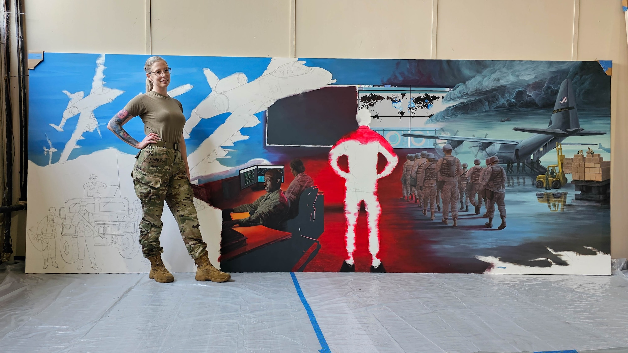 Maryland Air National Guard Staff Sgt. Rachel Underwood, public affairs specialist for the 175th Wing, takes a self portrait standing in front of her in-progress acrylic mural at Warfield Air National Guard Base at Martin State Airport, Maryland, June 1, 2023.