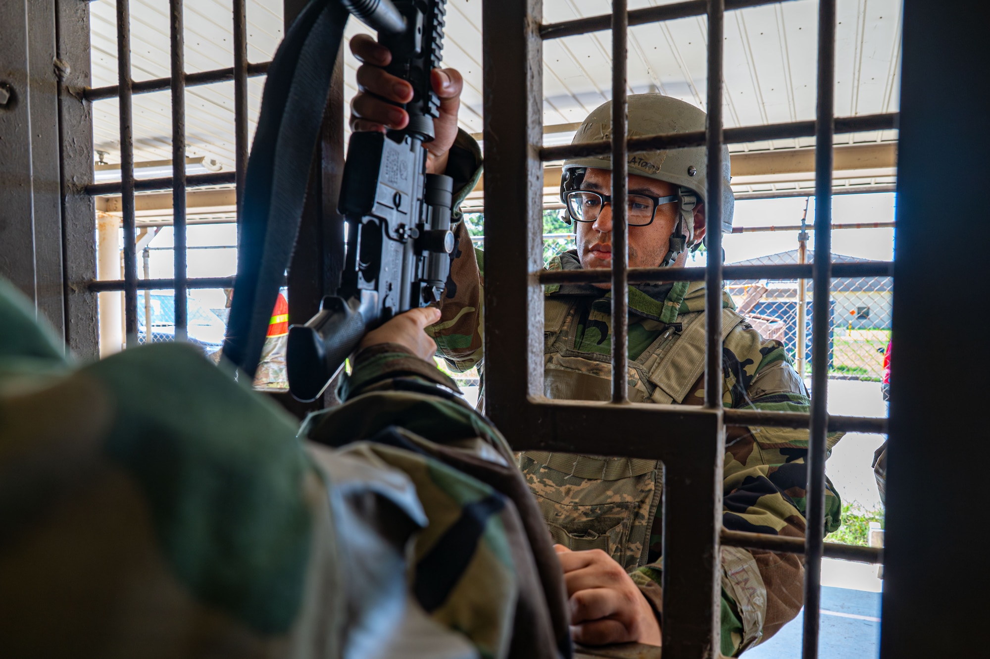 A man reaches for a gun through a wall.