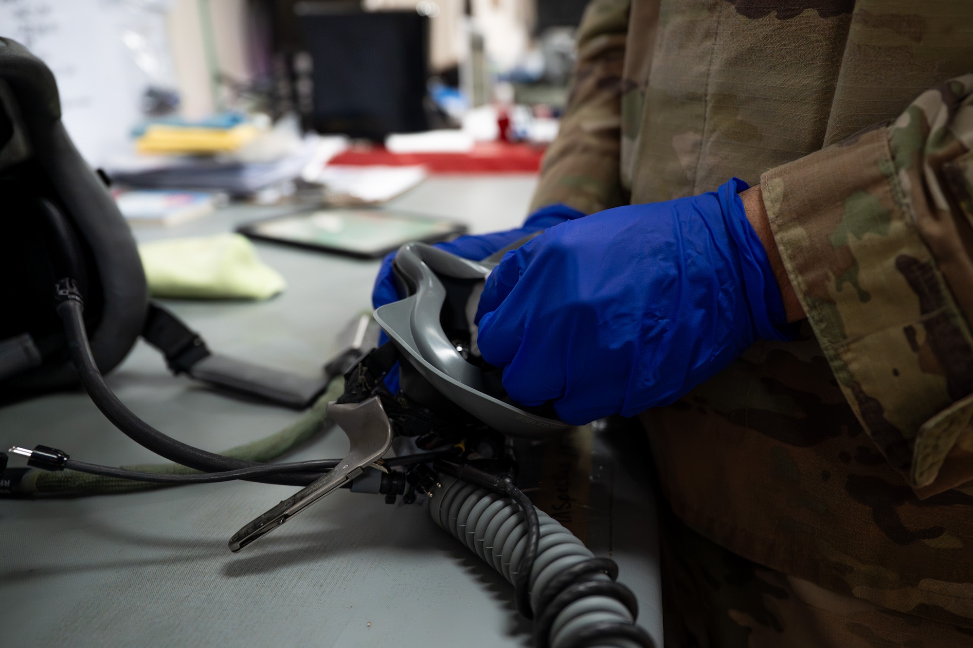 Airman cleans an oxygen mask with isopropyl alcohol