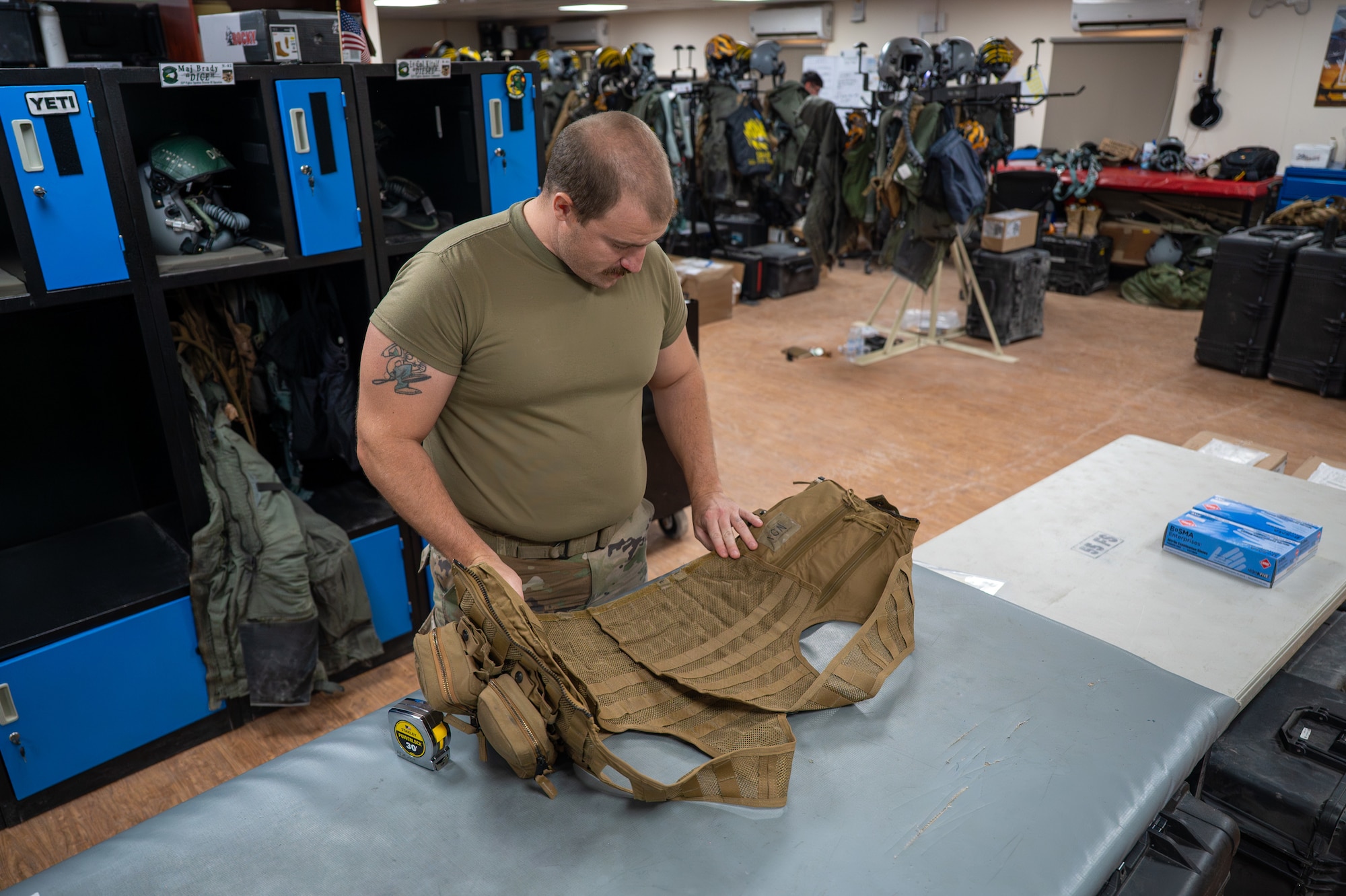 Airman visually inspects an Airsave survival vest
