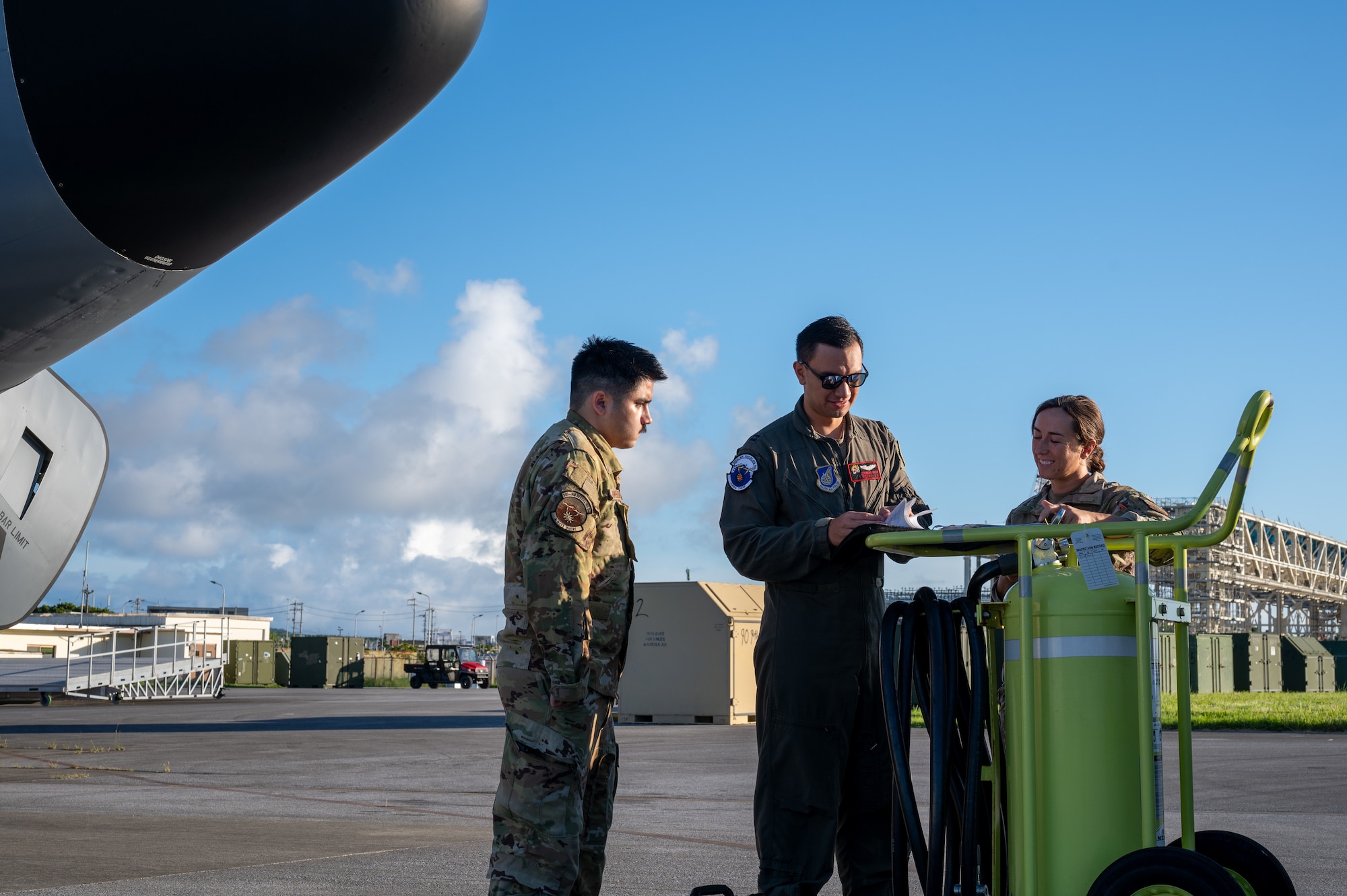 military members stand infront of a KC-135 planning with eachother before a flight