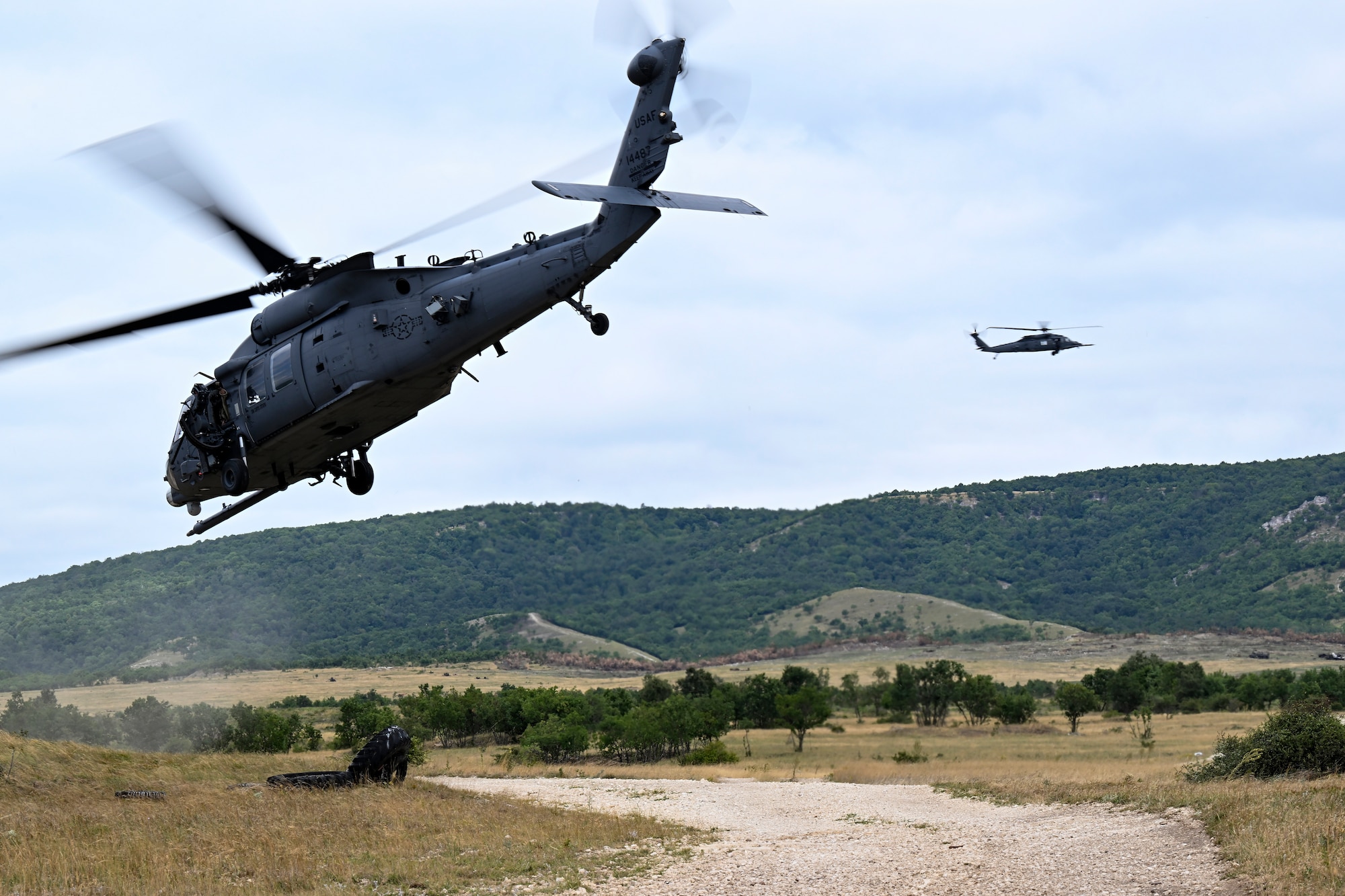 Two helicopters flying