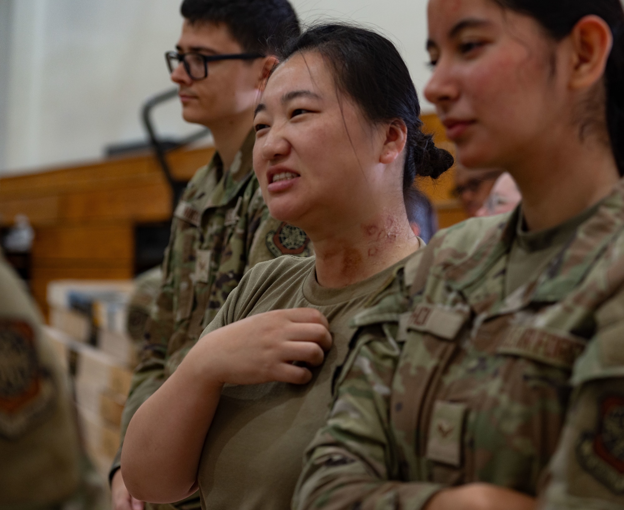 U.S. Air Force Airman 1st Class Xuan Song, center, 87th Medical Group medical technician, performs as a simulated Anthrax casualty during a Public Health Emergency exercise at Joint Base McGuire-Dix-Lakehurst, N.J., Aug. 7, 2025. Body makeup was used to simulate the patient’s exposure to Anthrax and provide a more realistic scenario for 87th MDG Airmen to train.