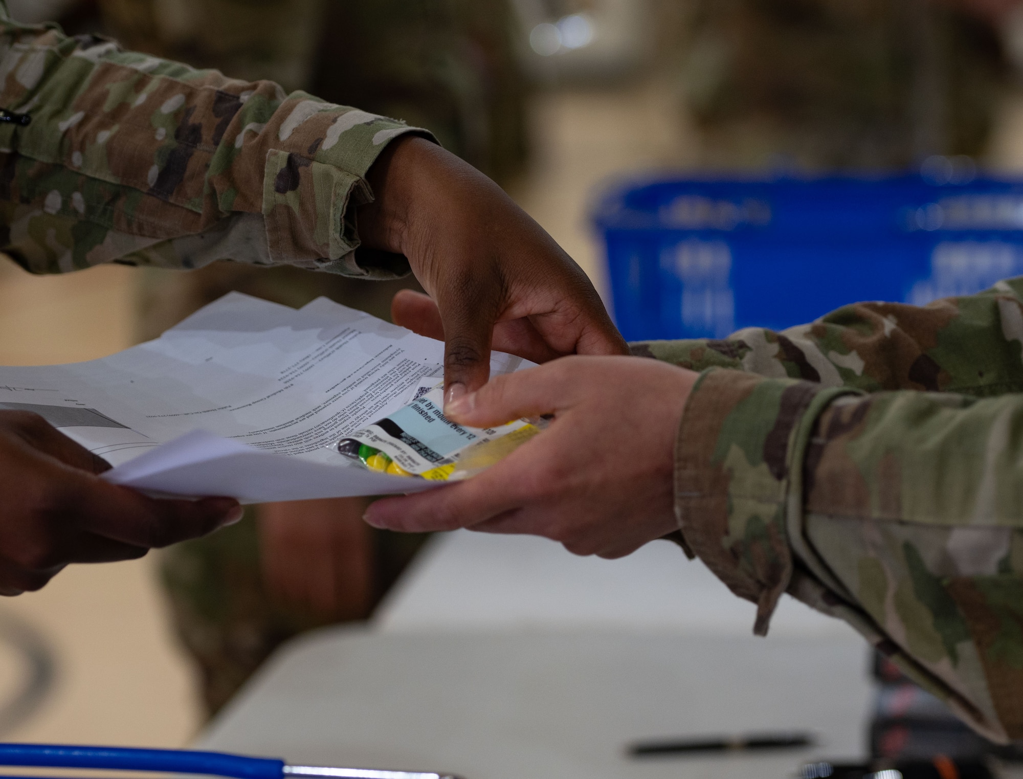 U.S. Air Force Airmen receive medication as part of a Public Health Emergency exercise simulating a base-wide Anthrax exposure at Joint Base McGuire-Dix-Lakehurst, N.J., Aug. 7, 2025. This exercise aimed to help Airmen practice quickly dispensing medication and triaging large, affected populations in the event of a real-world public health emergency.