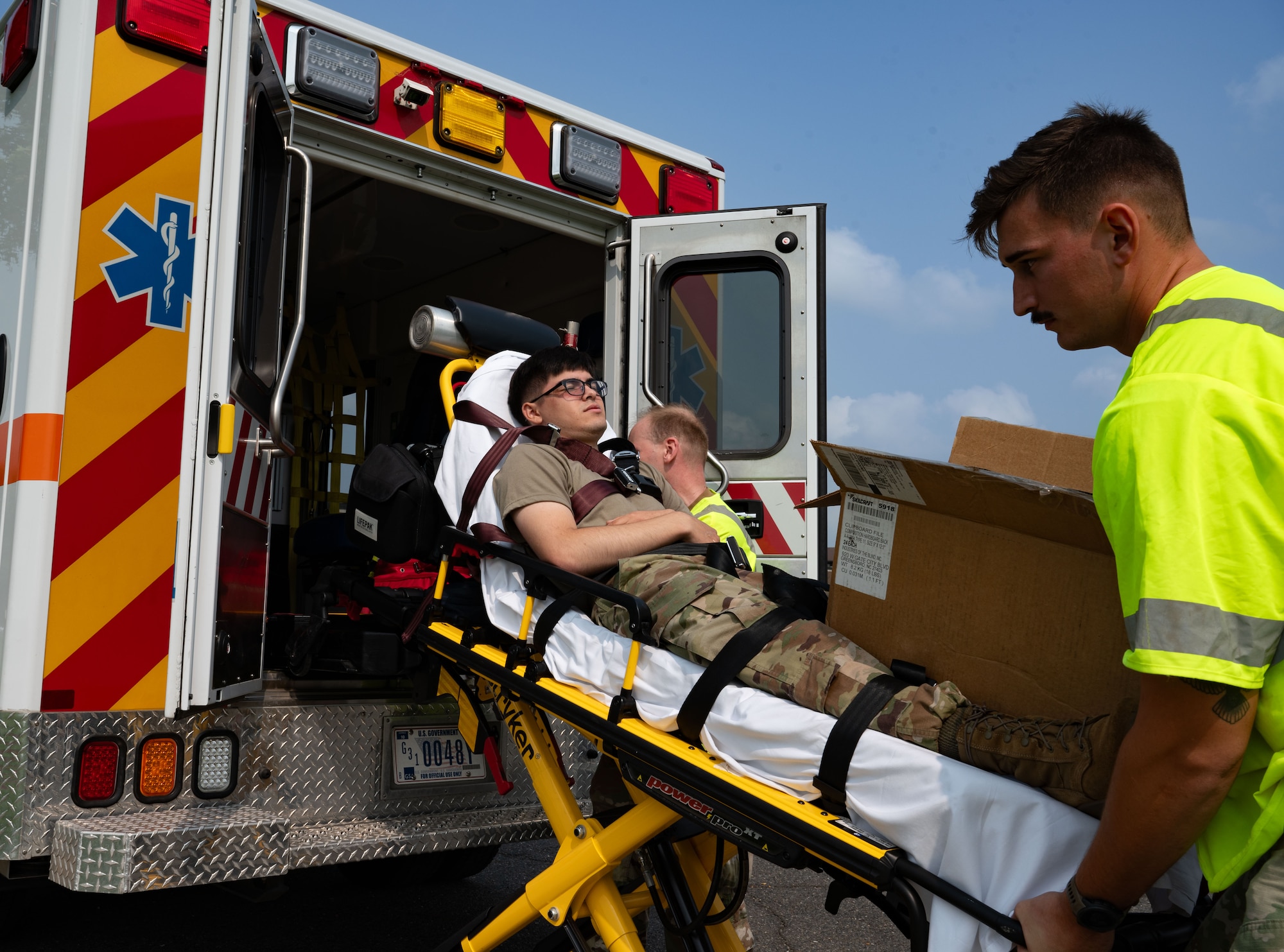 U.S. Air Force Senior Airman Harlan Watson, 87th Medical Group paramedic, loads Airman Marcus Garza, 87th Logistics Readiness Squadron ground transportation apprentice, into an ambulance during a Public Health Emergency exercise at Joint Base McGuire-Dix-Lakehurst, N.J., Aug. 7, 2025. Multiple agencies across the installation, as well as civilian representatives, took part in the exercise to provide the most accurate training scenario in the event of a public health emergency.