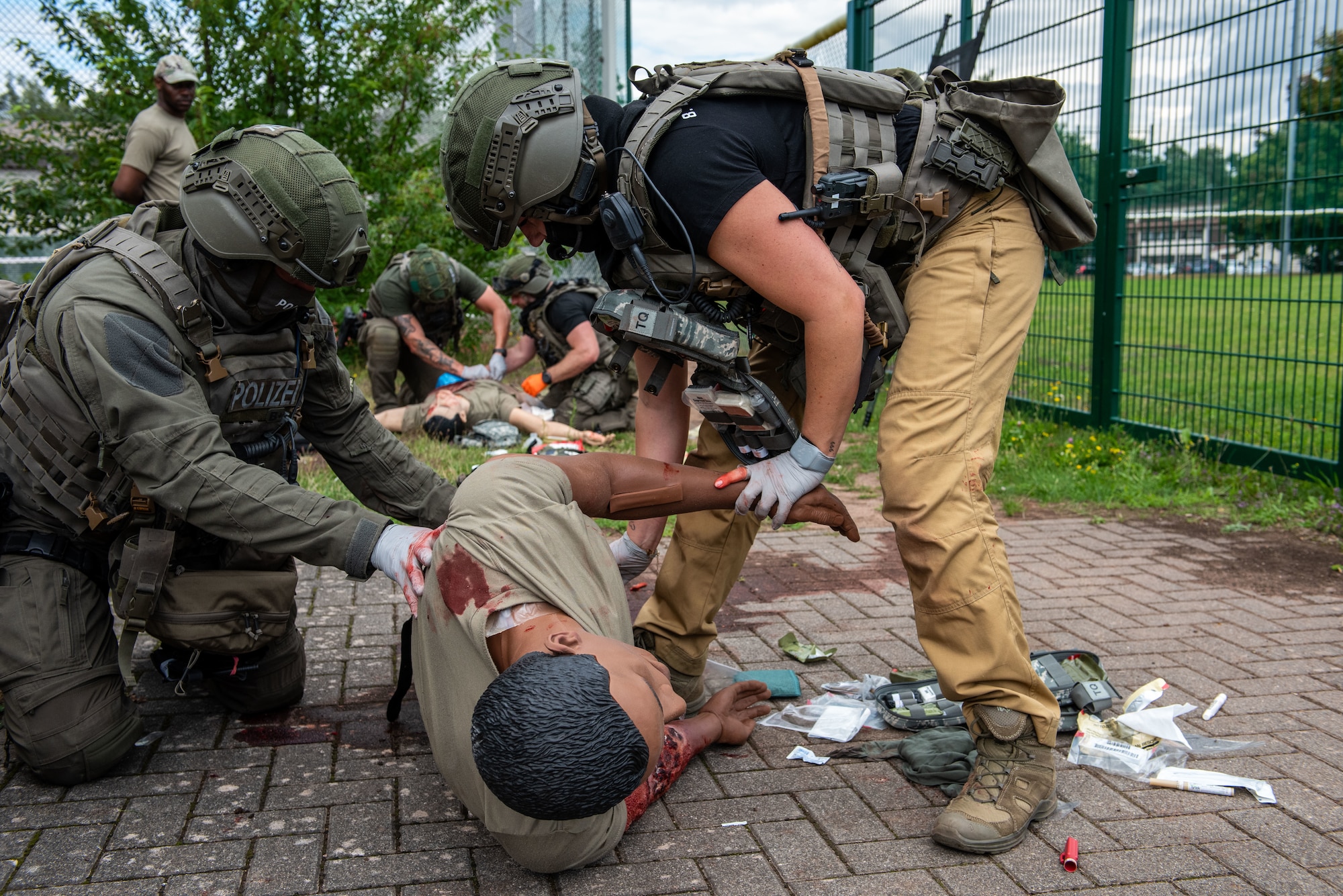 German SWAT officers position a mannequin for a blood sweep during Tactical Combat Casualty Care training at Ramstein Air Base, Germany, July 30, 2025. The 86th Medical Group held its second iteration of Tactical Combat Casualty Care training for the officers, further strengthening the relationship between German police and the U.S. Air Force. (U.S. Air Force photo by Airman 1st Class Joseph Curzi)