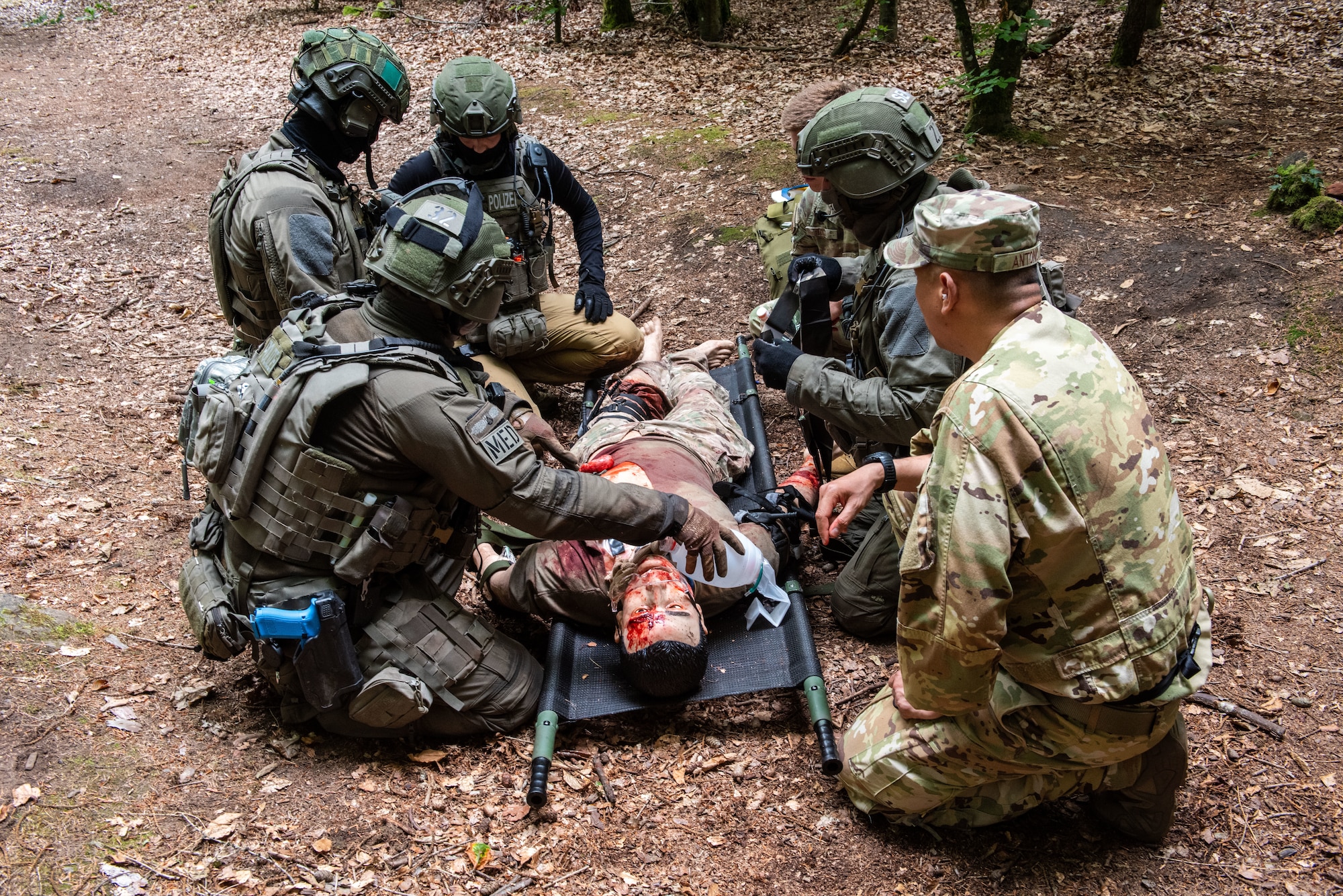 Airmen assigned to the 86th Medical Group and German SWAT officers discuss training plans during Tactical Combat Casualty training at Landstuhl, Germany, July 31, 2025. The 86th Medical Group held its second iteration of Tactical Combat Casualty Care training for the officers, further strengthening the relationship between German police and the U.S. Air Force. (U.S. Air Force photo by Airman 1st Class Joseph Curzi)