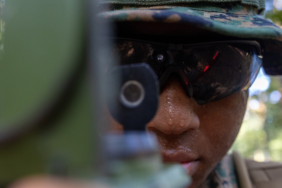 U.S. Marine Corps Lance Cpl. Classic Titus, an administrative specialist with 2nd Battalion, 2nd Marine Regiment, shoots an azimuth with a compass while practicing land navigation alongside Marines with Combat Logistics Battalion 22, Combat Logistics Regiment 27, at Marine Corps Base Quantico, Virginia, July 26, 2025. The logistics combat element of the Special Purpose Marine Air-Ground Task Force – Alert Contingency MAGTF (SPMAGTF-ACM), CLB-22, conducted a deployment for training to increase proficiency in comprehensive combat service support and improve overall combat readiness for any potential MAGTF missions. (U.S. Marine Corps photo by Lance Cpl. Jack Labrador)