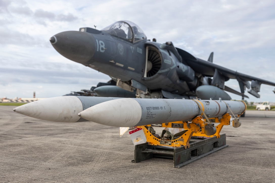 U.S. Marines with Marine Attack Squadron (VMA) 223 prepare AIM-120 AMRAAM missiles for loading onto an AV-8B Harrier II at Marine Corps Air Station Cherry Point, North Carolina, Aug. 5, 2025. Marines with VMA-223 conducted a live-fire training event to refine tactics and techniques and to continue to maintain mission excellence and readiness. (U.S. Marine Corps photo by Lance Cpl. Bryan Giraldo)