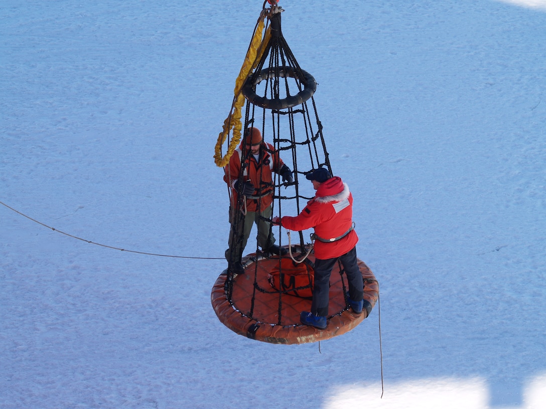 CRREL's George Blaisdell and a colleague are lifted by helicopter off the Ross Sea ice onto the deck of the research icebreaker Nathaniel B. Palmer. Blaisdell’s work in the Antarctic and other extreme cold regions recently earned him admittance to The Explorers Club.