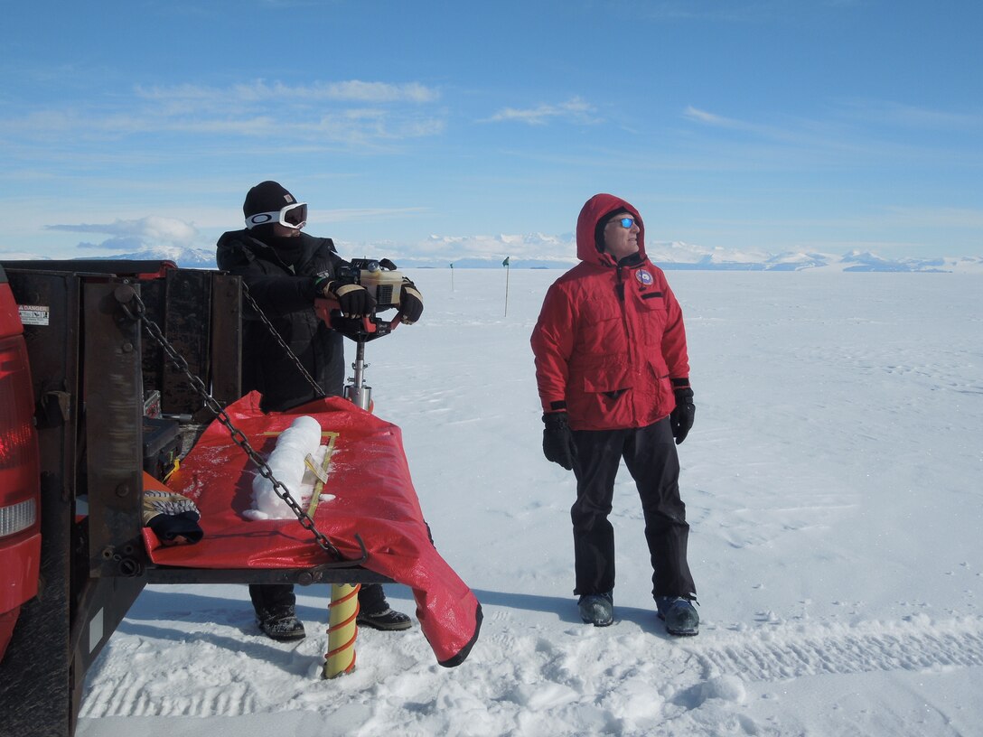 CRREL's George Blaisdell and TJ Melendy pause to watch mini eruptions on Mt. Erebus while drilling core samples during the development of the Phoenix compacted snow runway. Blaisdell’s work in the Antarctic and other extreme cold regions recently earned him admittance to The Explorers Club.
