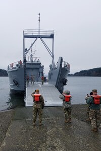 Soldiers prepare a logistics support vessel to receive cargo before the start of a mission in Baltimore, Maryland that is traveling to Washington state.