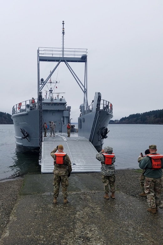 Soldiers prepare a logistics support vessel to receive cargo before the start of a mission in Baltimore, Maryland that is traveling to Washington state.